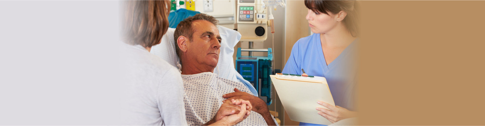 nurse giving details to patient on bed